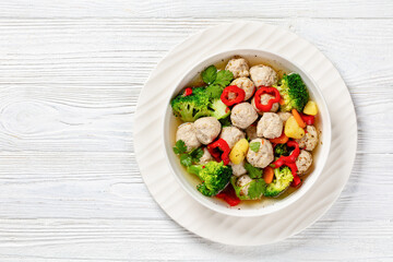 chicken meatball soup with vegetables in a bowl