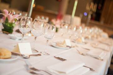 Beautiful table setup with glassware and flowers for a special event, like a celebration or formal dinner
