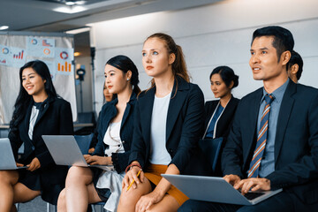 Young Asian and Caucasian audience sitting and listen to speaker in group meeting presentation at...