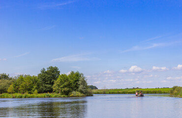 Obraz premium People taking a boat trip on the Vecht river between Hardenberg and Gramsbergen, Netherlands