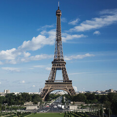 an image of Eiffel Tower seen from sky with background of clean blue sky
