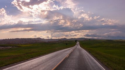 A lonely road on the prairie toward Badlands National Park after a summer storm, South Dakota