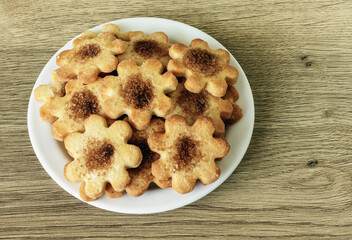 on a plate a bunch of cookies with cinnamon and sugar on the table