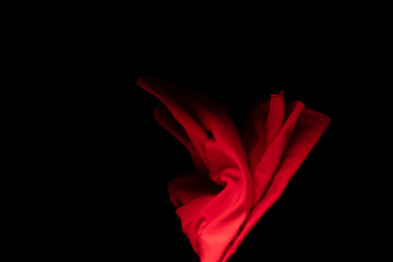 Red Cotton fabric flying in curve shape, Piece of textile Red cotton fabric throw fall in air....