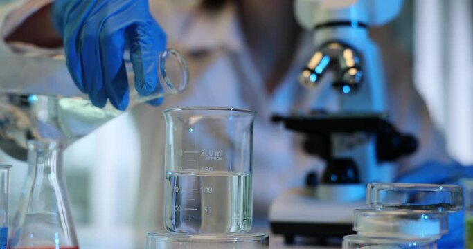 Chemical laboratory experiment pouring and mixing liquid