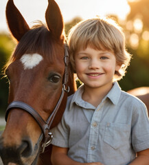 Fototapeta premium Portrait of happy little boy with a horse on a nice summer day. Interacting with horses encourages emotional bonding and can help children develop trust, empathy, confidence and help reduce anxiety