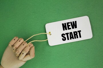 tag the paper with the word new start. new beginning concept. resolution to start the year