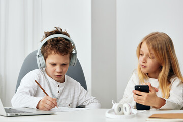 Happy Caucasian Boy and Girl Studying at Home with Laptops, Engaged in ELearning