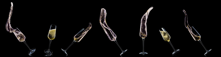 Glass for champagne with splashes isolated on black background.