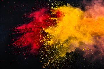 
Red and yellow colored powder explosions on black background. Holi paint powder splash in colors of Spanish flag