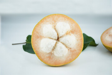 Santol cut that can see seed on white background.