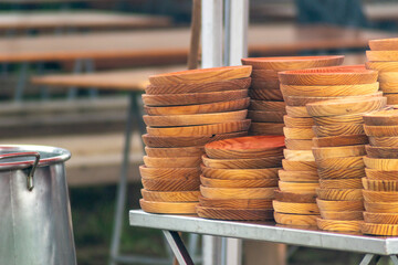 Stacked typical wooden plates at a stall selling octopus a feira, Galicia. Spain