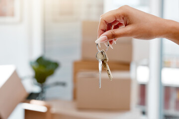 Hand, keys and new home with moving boxes or real estate investment or approval, mortgage or...