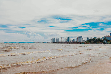 beach near city with blue sky