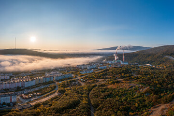 Morning panorama of the city. Aerial view of a combined heat and power plant on the outskirts of...