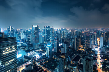 Fototapeta premium City Skyline at Night: Aerial View of Illuminated Skyscrapers