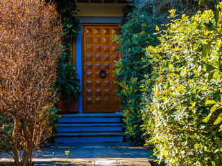 A contemporary design house entrance corridor in the garden and a wooden door. Travel to Athens,...