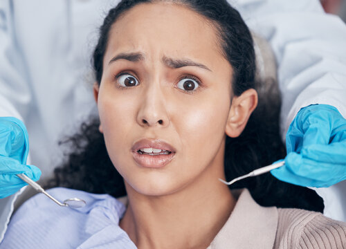 Patient, girl and fear with portrait for dental checkup or procedure, anxiety and nervous for tooth extraction. Client, woman and scared with dentist for teeth whitening or phobia, mouth and clinic.