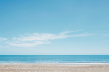 Fototapeta premium Sunlit Beach with Blue Sky and Ocean View