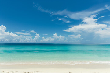 Obraz premium Sunlit Beach with Blue Sky and Ocean View