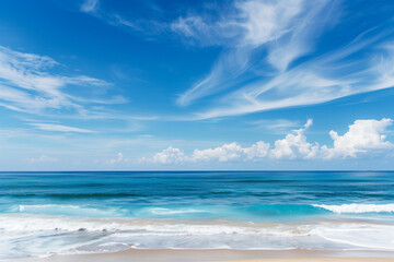 Obraz premium Sunlit Beach with Blue Sky and Ocean View