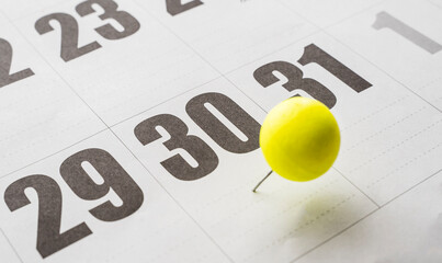 30th of the month on the calendar marked with a yellow ball. Thirtieth day of the month marked with...