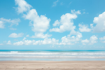 Obraz premium Sunlit Beach with Blue Sky and Ocean View