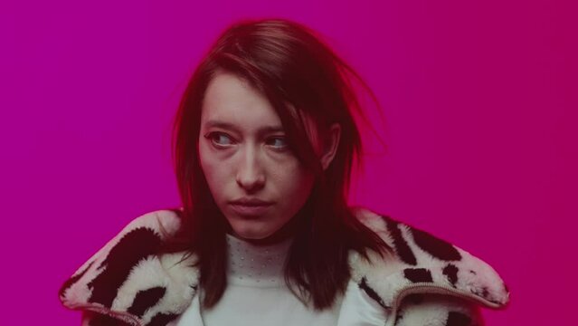 An adult woman in zebra print jacket isolated on neon pink color background. Upset lesbian or bisexual girl. Stressed lady with bruises under her eyes. Stop hating people other orientation