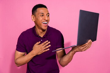 Photo portrait of attractive young man hold netbook video call laugh dressed stylish violet clothes...
