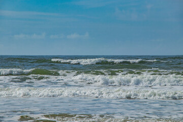 the beautiful green-blue North Sea with playful waves in Denmark