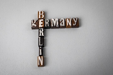 GERMANY BERLIN. Alphabet blocks, crossword puzzle on gray textured background