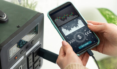 ICO concept - hand clicks on smartphone with abstract graphics.