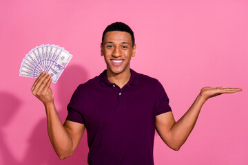 Photo portrait of handsome young guy hold money fan empty space wear trendy violet outfit isolated...