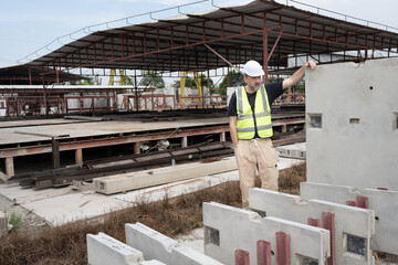 Portrait Caucasian engineer man working at precast cement outdoor factory	