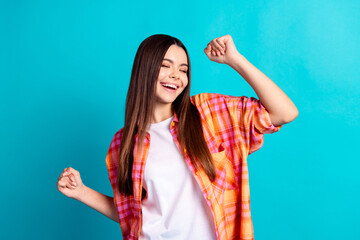Photo of nice young girl raise fists shout yes wear plaid shirt isolated on teal color background