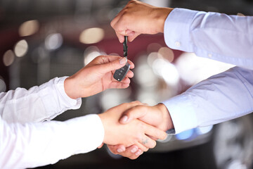 Car salesman, keys and handshake with client for deal, loan or finance for vehicle in showroom. People, shaking hands or agreement for discount, sale or transportation with good customer experience