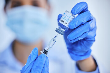 Person, hand and vaccine bottle with needle for treatment or control for virus, disease and liquid...