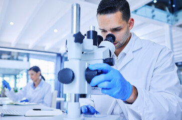 Microscope, man and scientist with research in lab, tech and tablet for report of results and observe. Medical, science and person in pharmacy, healthcare and check for medicine, test or innovation