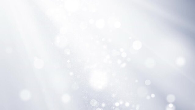 Elegant glowing silver white bokeh background with moving light rays particles.