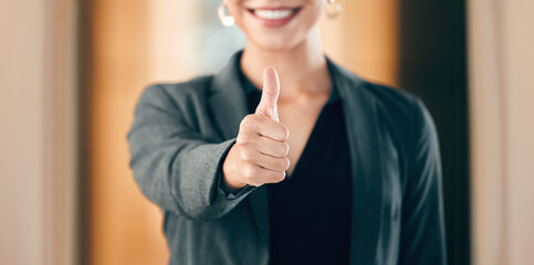 Hand, thumbs up and business woman show support, thank you and smile in office for success in...