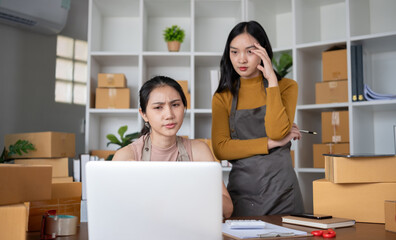 Two young Asian women who are worried Was stressed while running a small business together having...