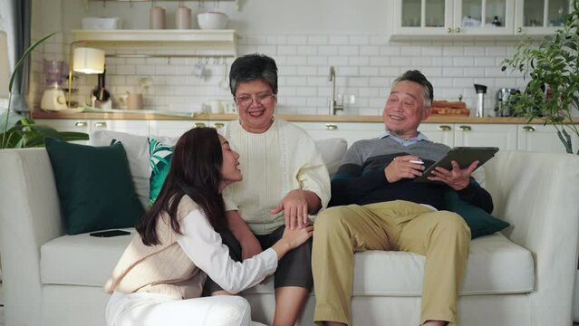 Asian daughter shared a moment of joy with her parent, engaging in a lively conversation that brought laughter and smiles. embraced in a warm hug, cherishing the special bond between them