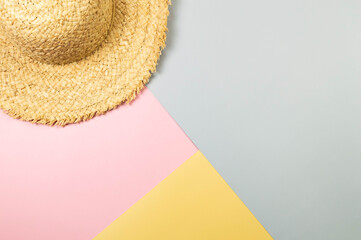 Top view of straw hat on colourful background. Summer fashion, vacation and beach wallpaper. Copy...