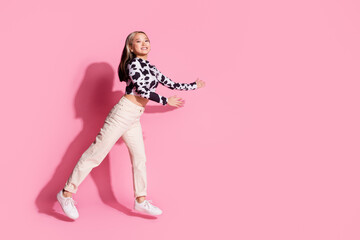 Full length photo of cheerful pretty lady dressed cow skin shirt jumping high showing arms empty space isolated pink color background