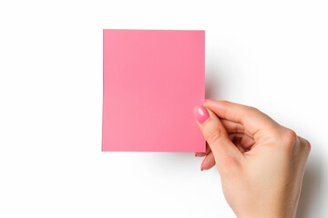 A woman's hand holds a blank pink card, ready for a message or business note, against a white background