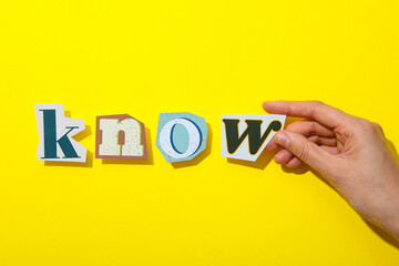 The word is laid out from letters on a yellow background.