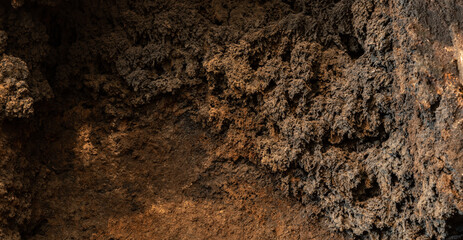 Black soot background in bright light. The inside of a clogged chimney pipe. Macro shot. Texture of...