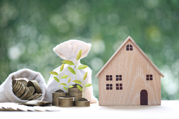 Finance, Model house with money bag on natural green background,Business investment and Save money...