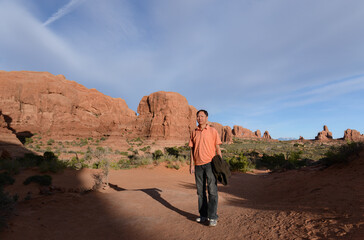 Portrait of a cheerful Chinese tourist at Arches National Park. Utah. USA.