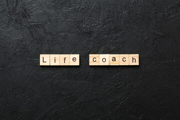 Life coach word written on wood block. Life coach text on cement table for your desing, concept